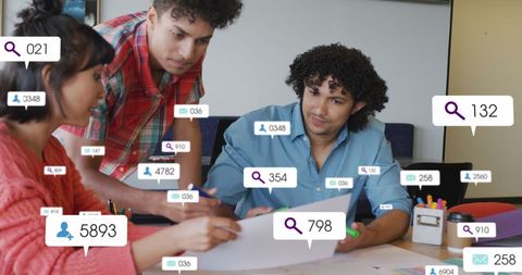 Architects collaborating on blueprint with social media notifiers
