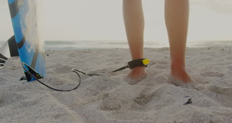 Surfer Preparing to Hit the Waves with Surfboard Leash