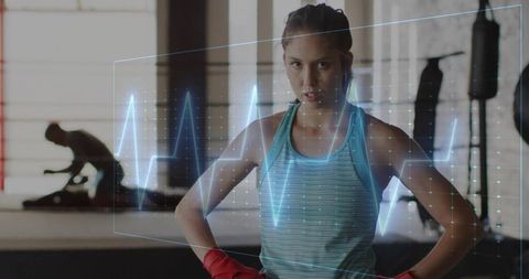 Young Female Boxer Visualizing Health Data in Gym