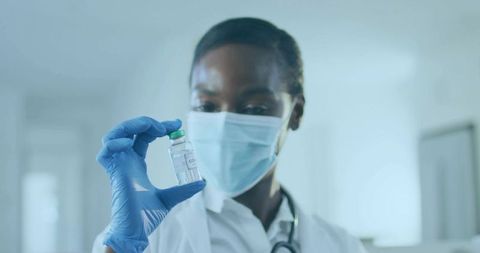 Doctor Holding COVID Vial in Medical Laboratory Setting