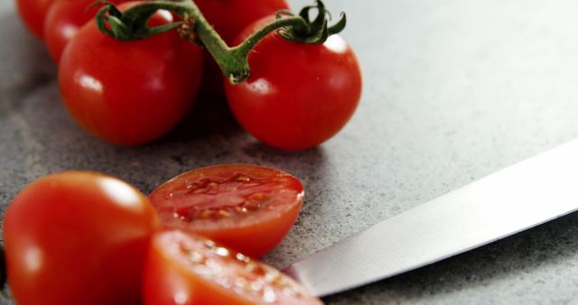 Fresh tomatoes are sliced on a kitchen counter, with copy space - Download Free Stock Photos Pikwizard.com