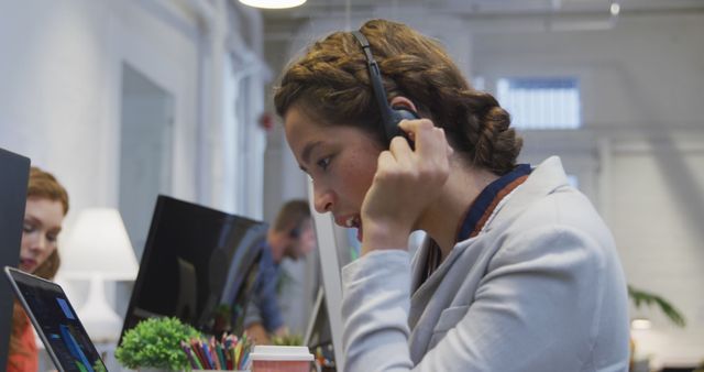 Customer Service Representative Assisting Client on Call in Modern Office - Download Free Stock Images Pikwizard.com