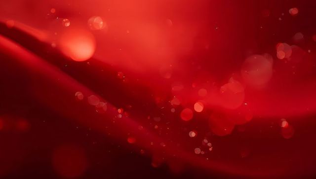 Glowing red flowing abstract background with bokeh orbs and sparkling particles