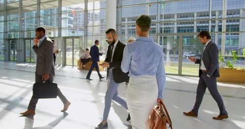 Diverse Businesspeople in Modern Office Lobby, Engaged in Activities - Download Free Stock Images Pikwizard.com