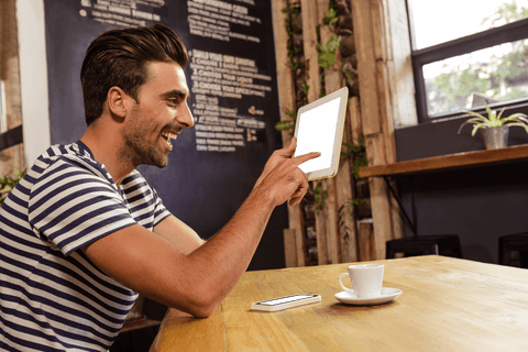 Transparent Tablet Usage in Cafe with Smiling Man - Download Free Stock Videos Pikwizard.com