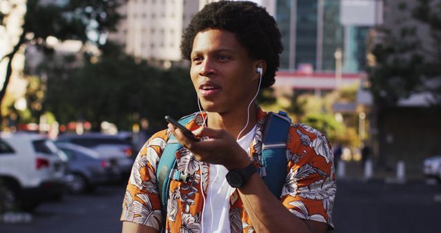 Young Man Using Smartphone Voice Assistant in Urban Cityscape - Download Free Stock Images Pikwizard.com