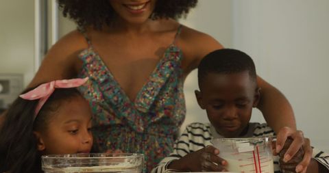 Smiling Mother Baking with Children at Home Kitchen