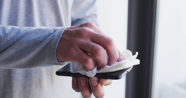 Man Cleaning Smartphone Screen with Disinfectant Wipe - Download Free Stock Images Pikwizard.com