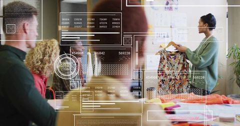 Creative team presenting patterned dress with ar overlays in fashion design workshop