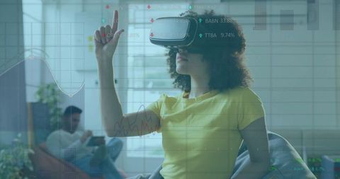 African American Woman Using VR Headset with Floating Virtual Charts Indoors