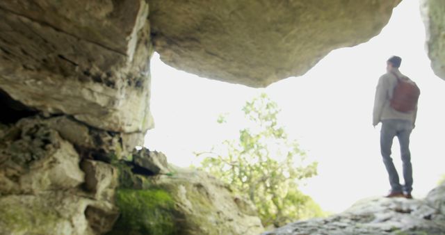 Explorer Standing in Rock Cave Entrance Overlooking Bright Outdoors - Download Free Stock Images Pikwizard.com