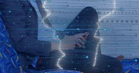 Businessman on blue seat using smartphone amidst digital overlay