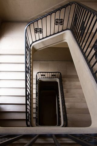 Looking Down Old Spiral Staircase in Historic Building