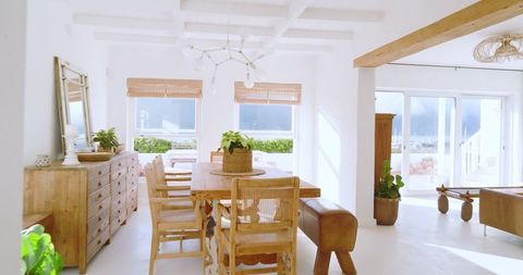Scenic coastal dining room with rustic furniture and ocean view