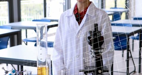 Student in science lab analyzing formulas around experiment table