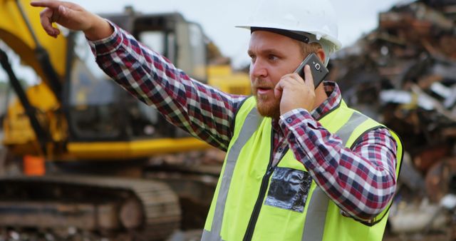 Construction Site Manager Communicating via Phone While Giving Instructions - Download Free Stock Images Pikwizard.com