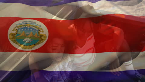 Couple Relaxing on Pickup Truck with Waving Costa Rican Flag Overlay