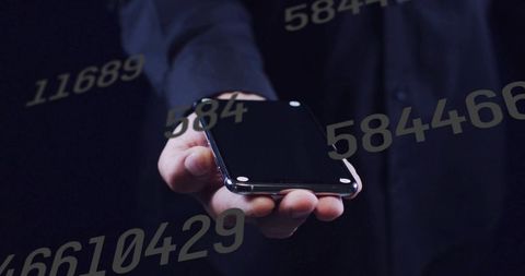 Extending hand holding smartphone with floating numbers overlay, digital data and security concept