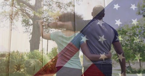 Romantic couple walking in park with american flag overlay