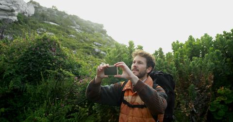 Person Capturing Outdoor Adventures on Scenic Nature Hike - Download Free Stock Images Pikwizard.com