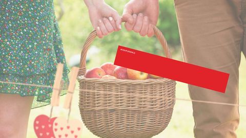 Couple holding basket of apples with hashtag text