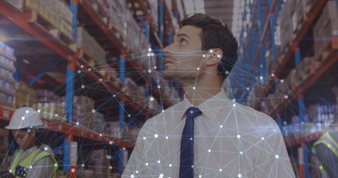 Supply Chain Manager Inspecting High Shelving and Inventory with Digital Network Overlay