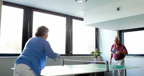 Senior Couple Enjoying Indoor Table Tennis Match - Download Free Stock Images Pikwizard.com