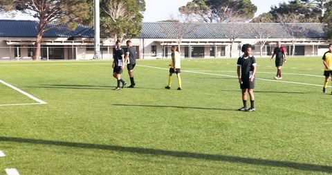 Youth soccer team preparing for match on sunny day