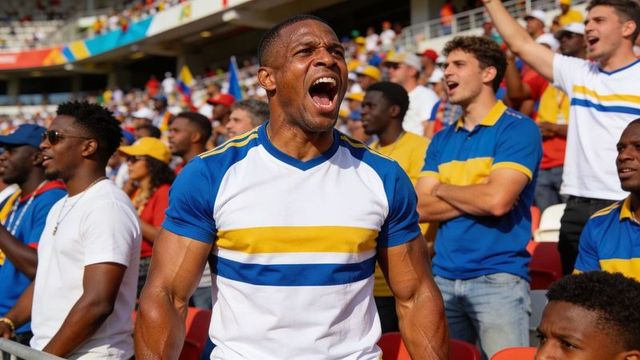 Energetic fan leading chant wearing blue and yellow striped shirt in packed stadium crowd