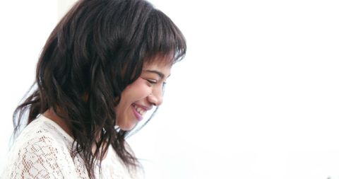 Smiling Young Asian Woman in Casual Attire Laughing Joyfully