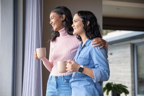 Women Enjoying Peaceful Moment By Sliding Glass Door