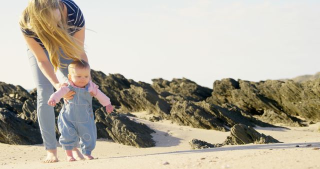 Mother Holding Baby Learning to Walk on Beach - Download Free Stock Images Pikwizard.com