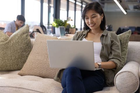 Businesswoman Relaxing in Stylish Office Lounge