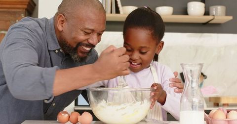 Father and Daughter Joyfully Baking Together in Modern Kitchen