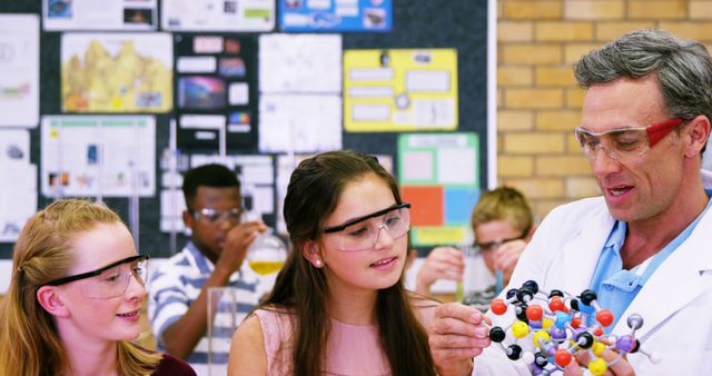 Teacher Guiding Students with Chemistry Model in Classroom - Download Free Stock Images Pikwizard.com