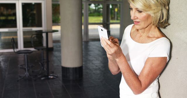 Middle-aged Woman Using Smartphone in Modern Environment - Download Free Stock Images Pikwizard.com