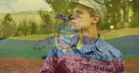 US Air Force Airman in Camouflage Holding Folder in Field with Ecuador Flag Double Exposure