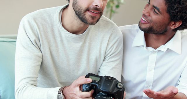 Young Men Discussing DSLR Camera in Cozy Living Room - Download Free Stock Images Pikwizard.com