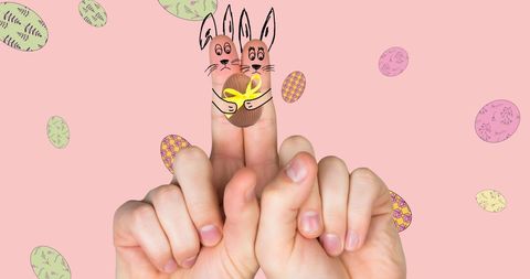 Fingers dressed as easter bunnies with colorful egg accents