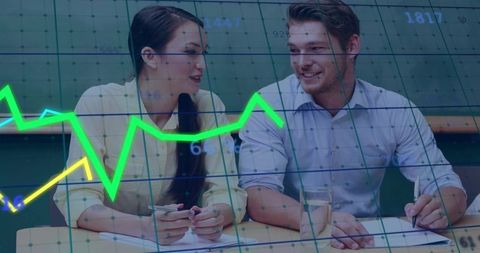 Collaborating over financial charts: colleagues discussing data-driven strategy