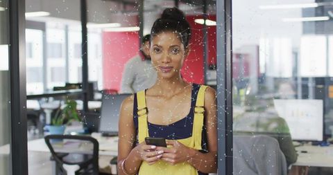 Businesswoman Managing Team with Smartphone at Modern Office