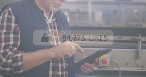 Industrial Worker Engaging with Social Media on Tablet