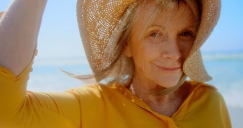 Senior Woman with Hat Smiling on Sunny Beach - Download Free Stock Images Pikwizard.com