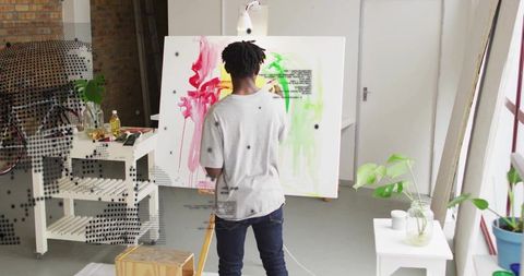 Artist Painting Abstract Art on Canvas in Modern Studio