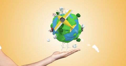 Hand Holding Miniature Earth with Airplane and Trees for Global Travel