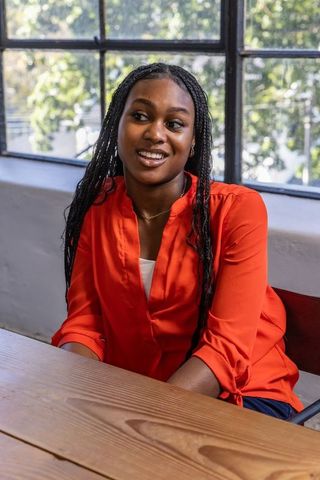 Smiling African American Woman at Study Table by Window