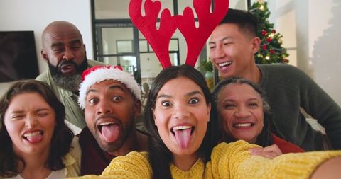 Diverse Friends Celebrating at Holiday Gathering with Fun Playful Selfie