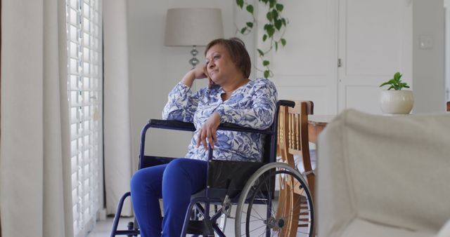 Senior Woman in Wheelchair Looking Thoughtful by Window - Download Free Stock Images Pikwizard.com