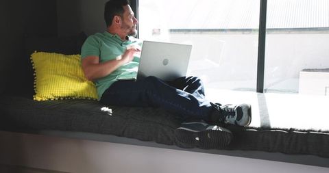 Casual Workday by Sunlit Window with Silver Laptop