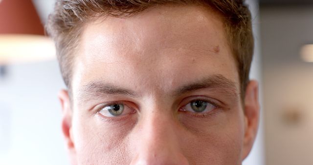 Portrait of caucasian businessman with brown hair and green eyes looking at camera at office - Download Free Stock Photos Pikwizard.com